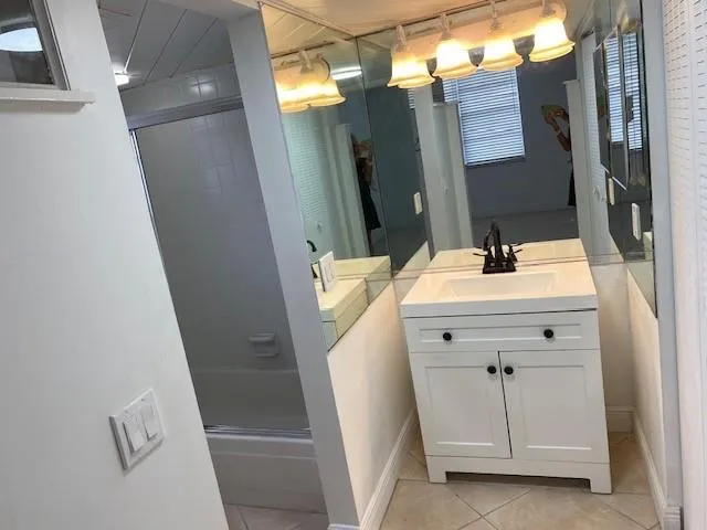 a bathroom with a sink and mirror