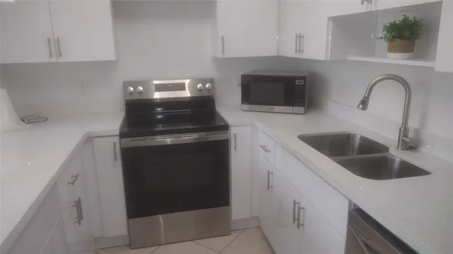 a kitchen with a sink and a stove top oven
