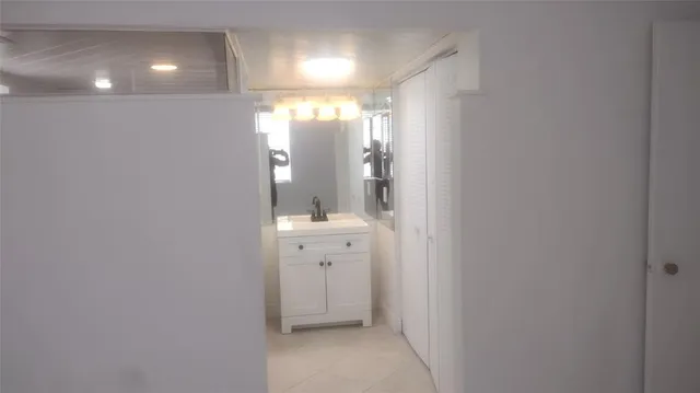 a bathroom with a glass shower door and a sink