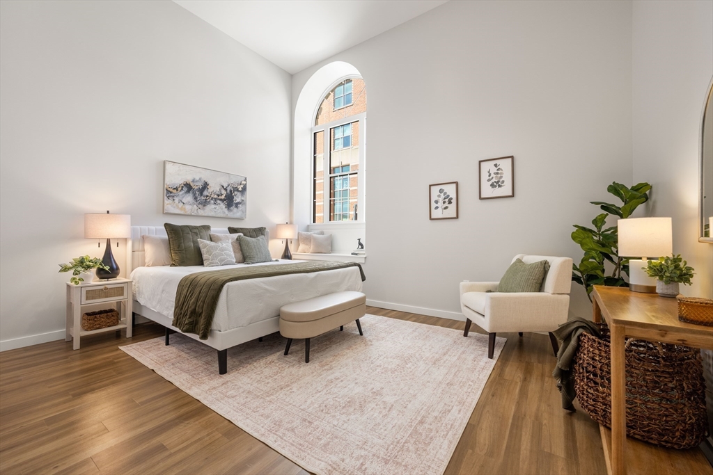 22 Elm Street, Unit 302 Worcester, MA 01608 - Photo 10 of 18 a spacious bedroom with a bed and wooden floor