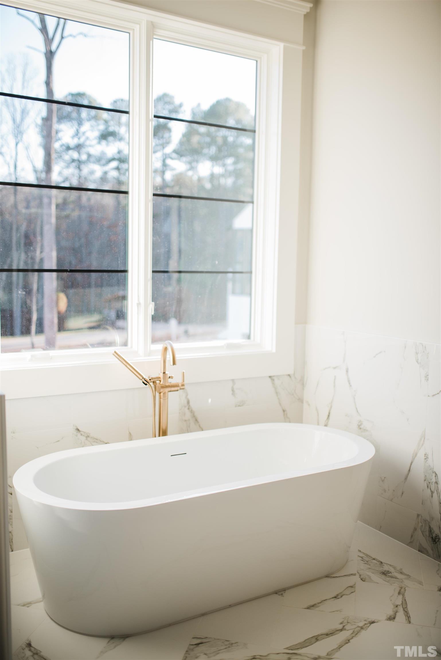 1000 Casa Dega Way Raleigh, NC 27615 - Photo 16 of 22 a white bath tub sitting next to a window