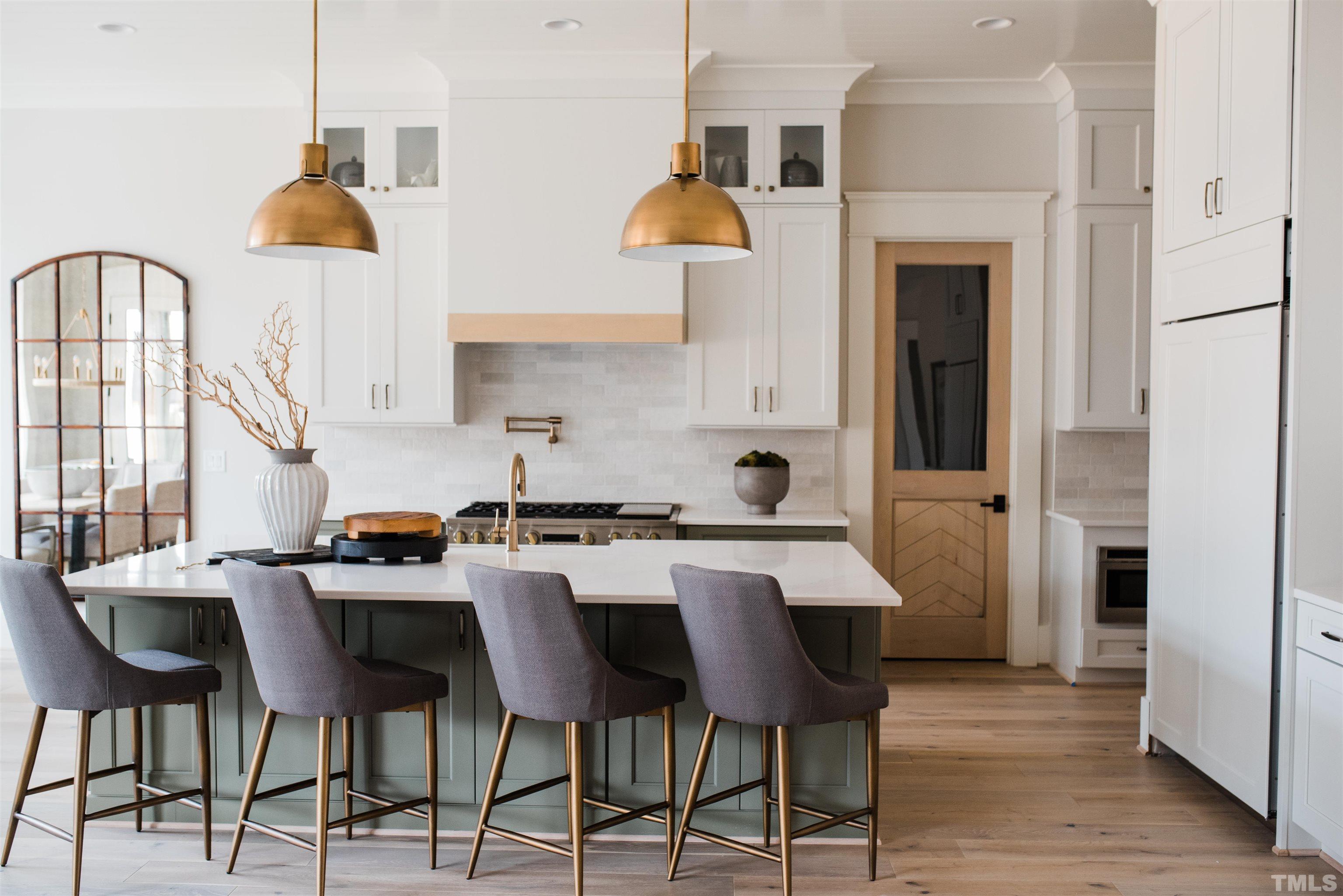 1000 Casa Dega Way Raleigh, NC 27615 - Photo 7 of 22 a kitchen with stainless steel appliances kitchen island granite countertop a table chairs in it and a window