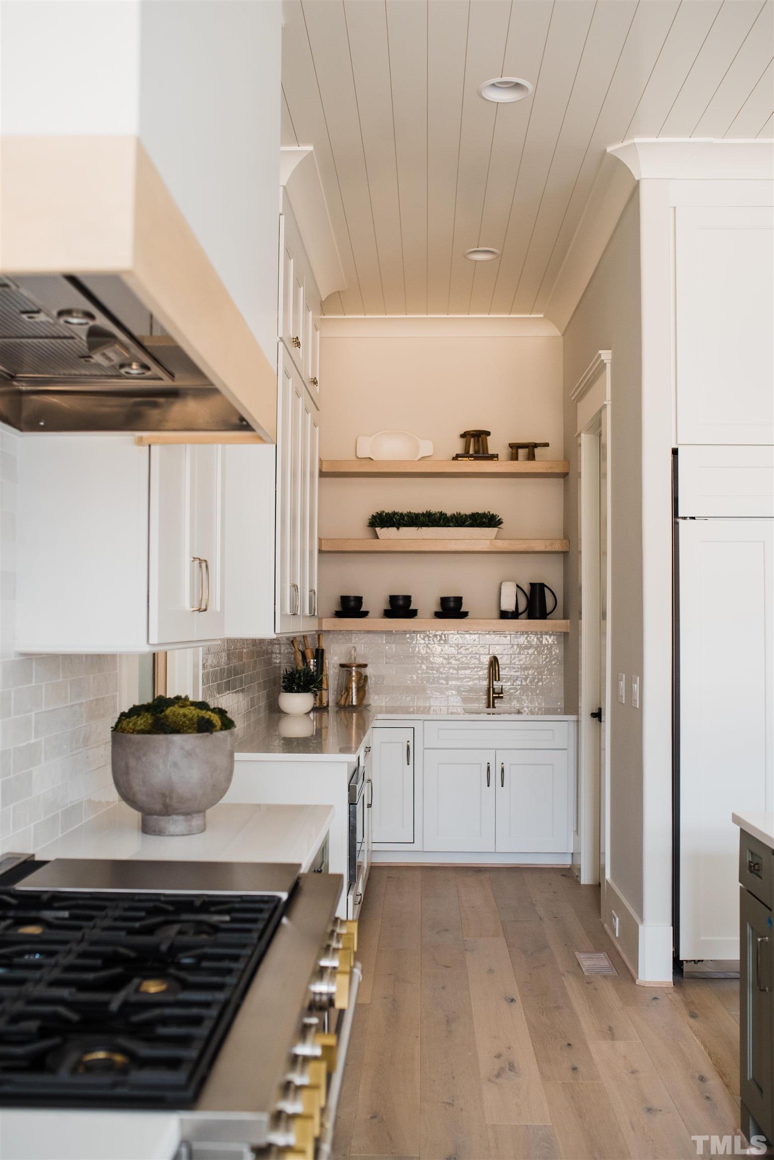 1000 Casa Dega Way Raleigh, NC 27615 - Photo 9 of 22 a kitchen with stainless steel appliances a stove and white cabinets