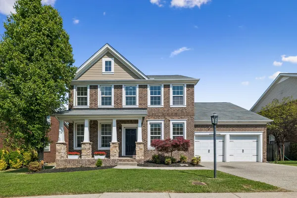front view of a house with a yard
