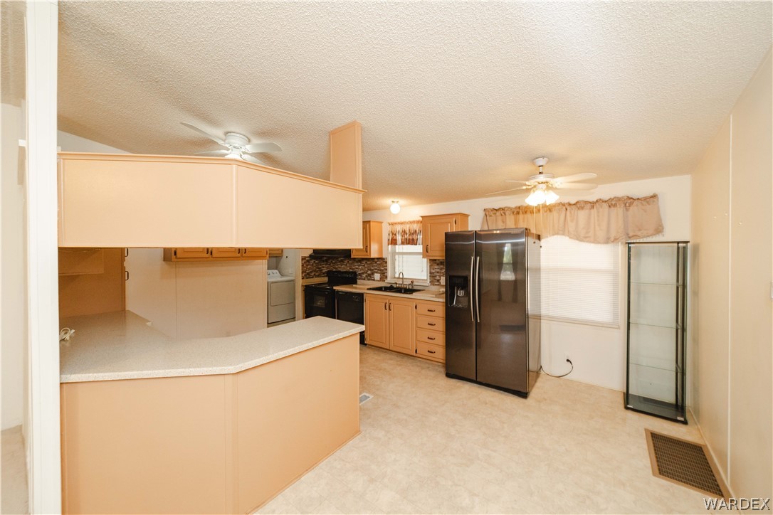 3003 Hualapai Mountain Road Kingman, AZ 86401 - Photo 9 of 49 a kitchen with a refrigerator and a stove