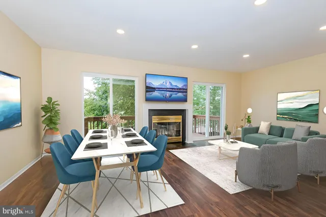 a living room with fireplace furniture and a large window
