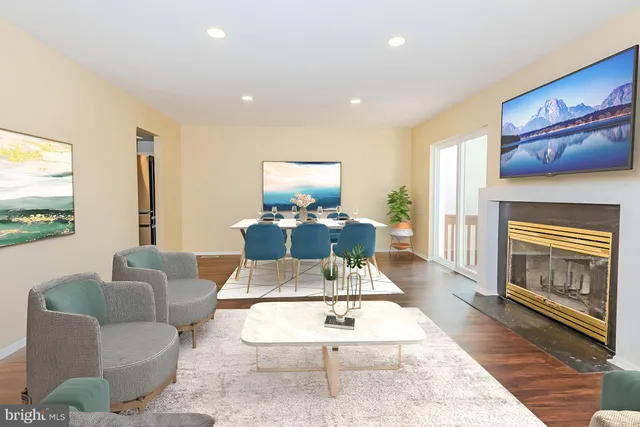 a living room with furniture a rug and a fireplace