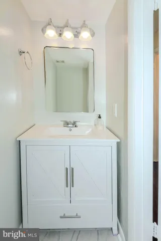 a bathroom with a sink a mirror and vanity