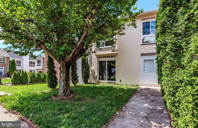 a front view of a house with yard and green space