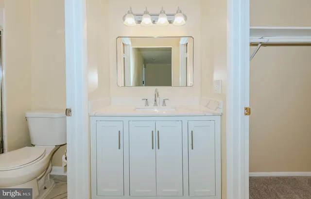 a bathroom with a toilet sink and mirror