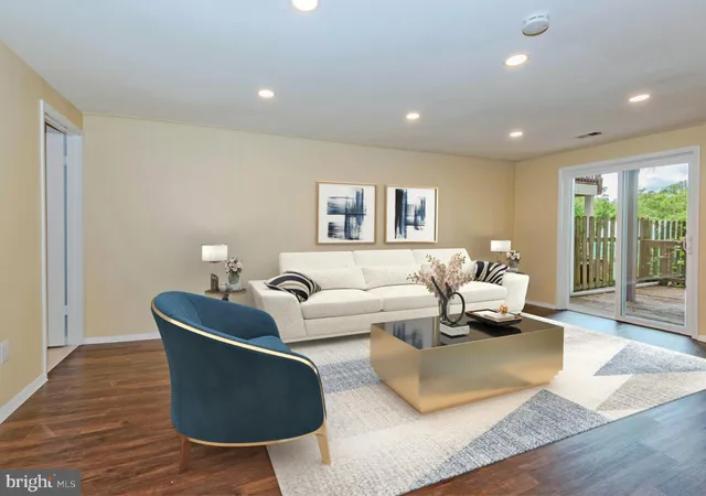 a living room with furniture window and a flat screen tv