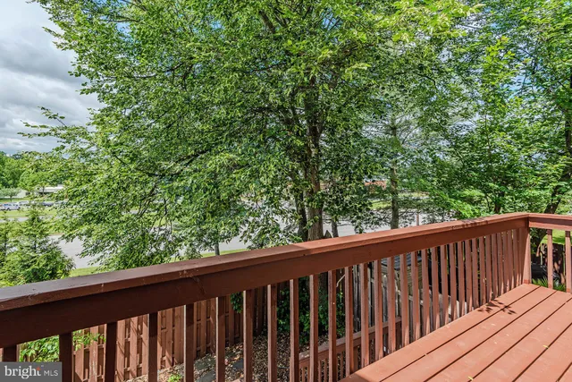 a view of a pathway of a house with wooden fence