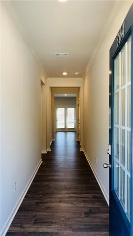 a view of a hallway with wooden floor