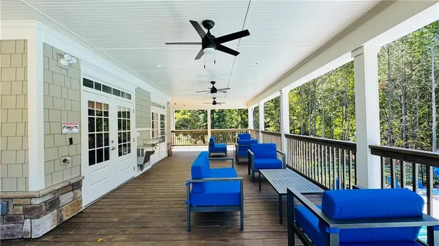 a view of a living room and balcony with furniture