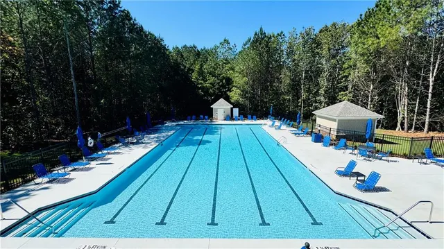 swimming pool view with a seating space