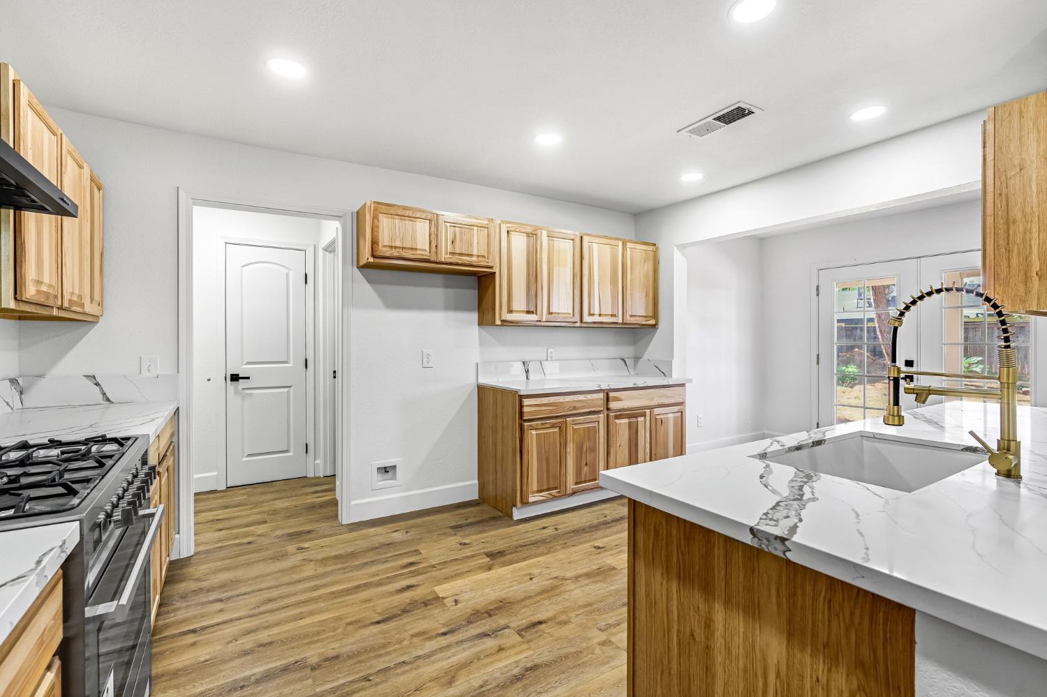 146 Sierra Avenue Clovis, CA 93612 - Photo 11 of 45 a kitchen with stainless steel appliances granite countertop a sink stove and cabinets