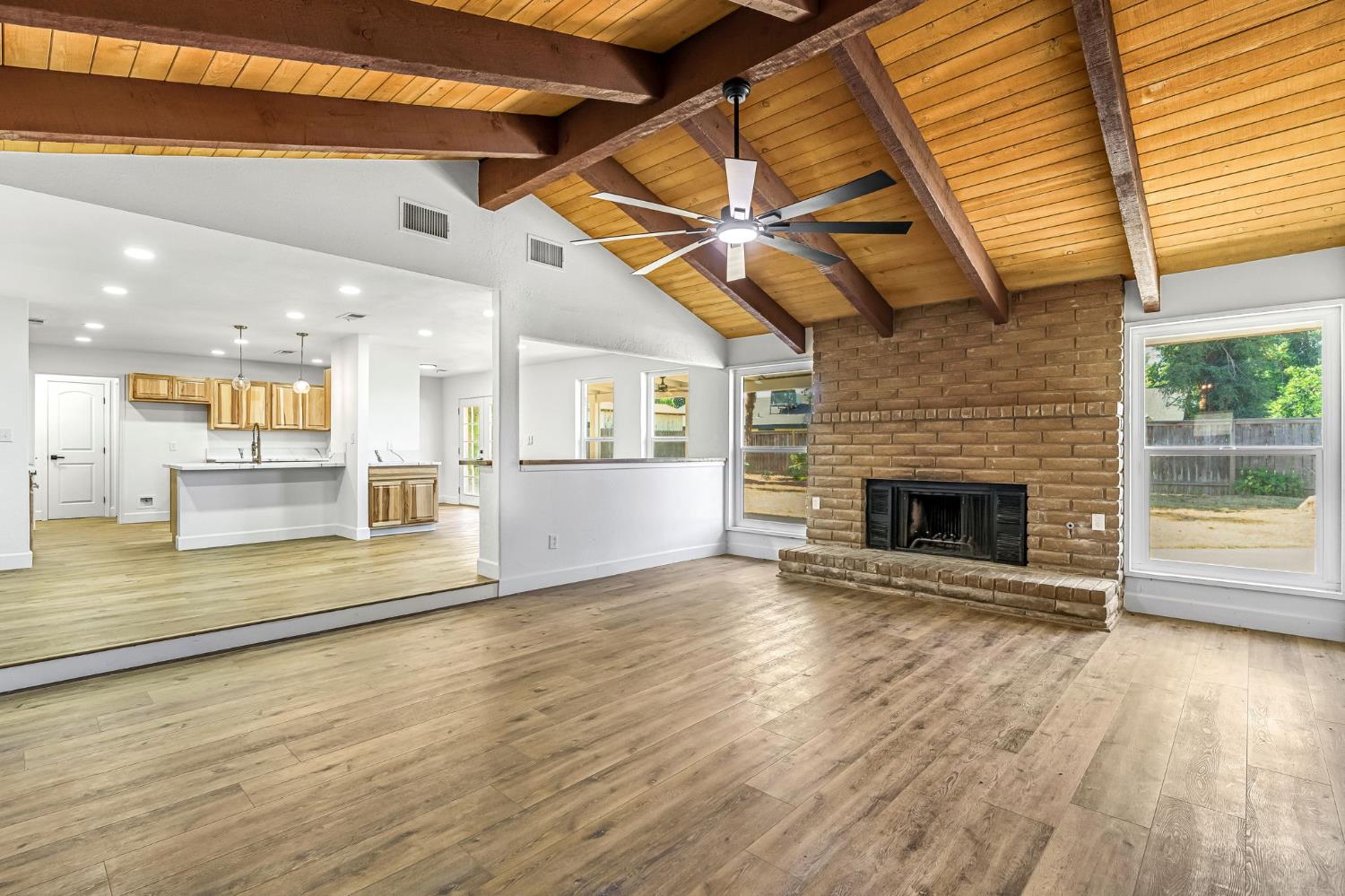 146 Sierra Avenue Clovis, CA 93612 - Photo 13 of 45 a view of a livingroom with fireplace wooden floor and windows