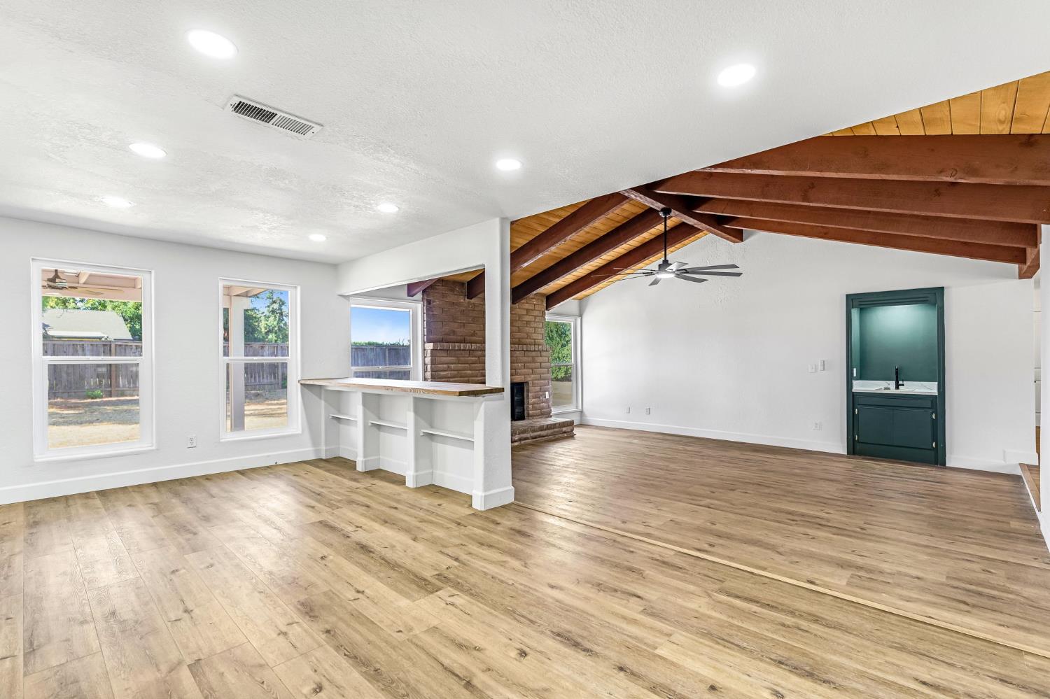 146 Sierra Avenue Clovis, CA 93612 - Photo 19 of 45 a view of empty room with wooden floor and kitchen