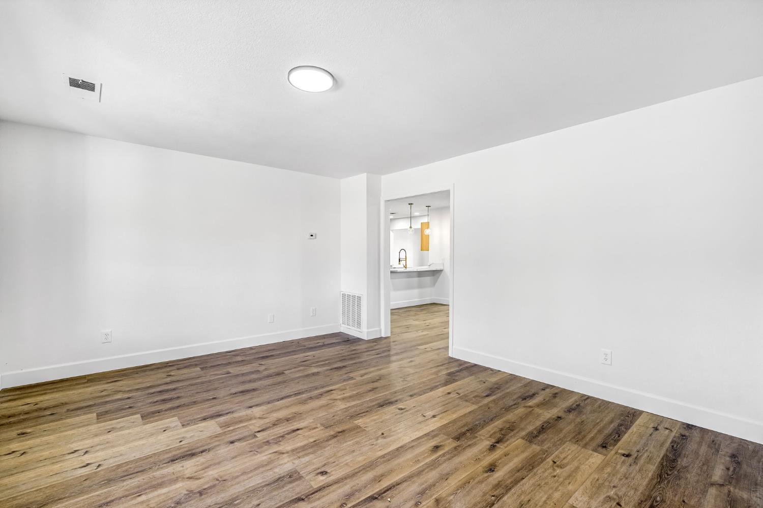 146 Sierra Avenue Clovis, CA 93612 - Photo 23 of 45 a view of an empty room with wooden floor and a window