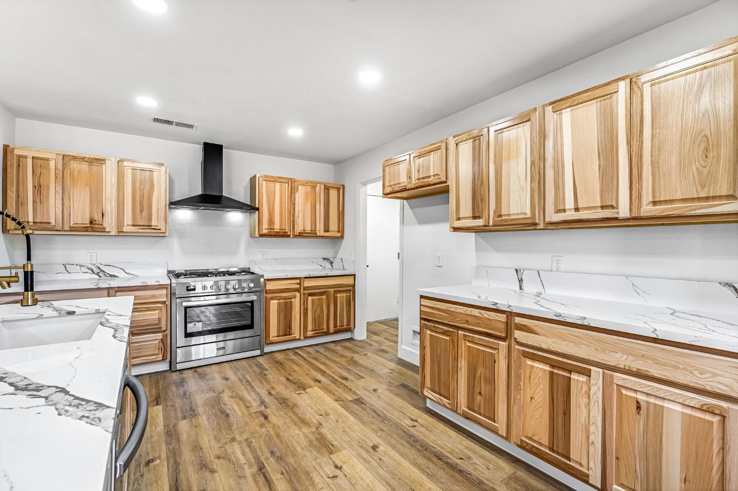 146 Sierra Avenue Clovis, CA 93612 - Photo 7 of 45 a kitchen with stainless steel appliances granite countertop a stove sink microwave and cabinets