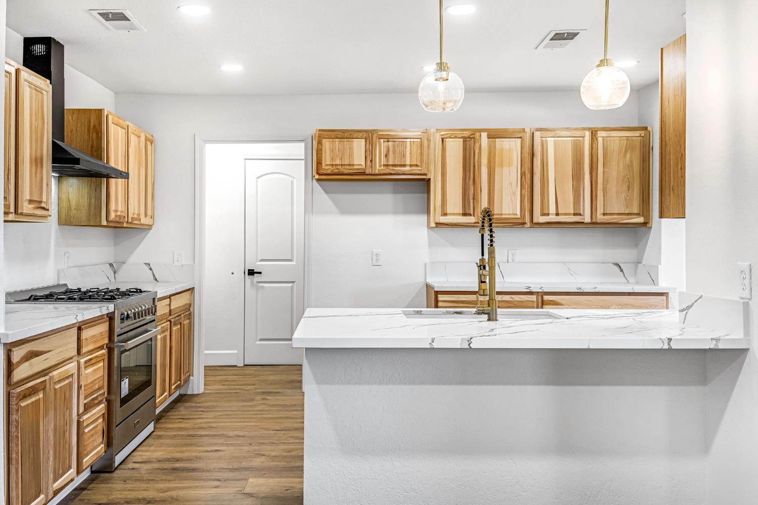146 Sierra Avenue Clovis, CA 93612 - Photo 9 of 45 a kitchen with stainless steel appliances granite countertop a sink a stove and a refrigerator