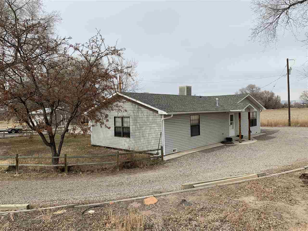965-19 19 1/2 Road Fruita, CO 81521 - Photo 3 of 30 front view of a house with a yard