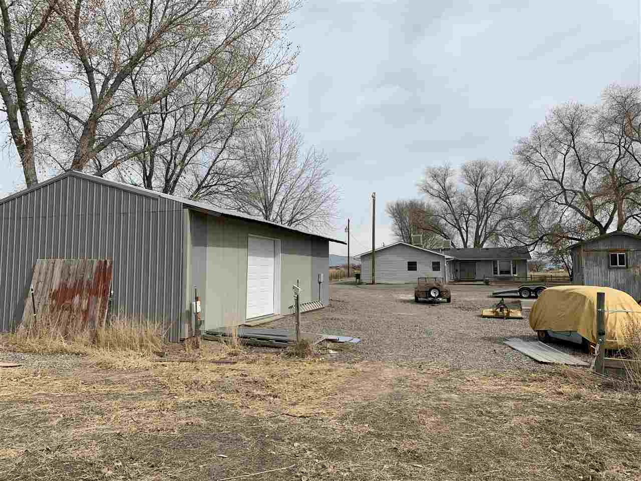 965-19 19 1/2 Road Fruita, CO 81521 - Photo 10 of 30 a backyard of a house with barbeque oven and wooden fence