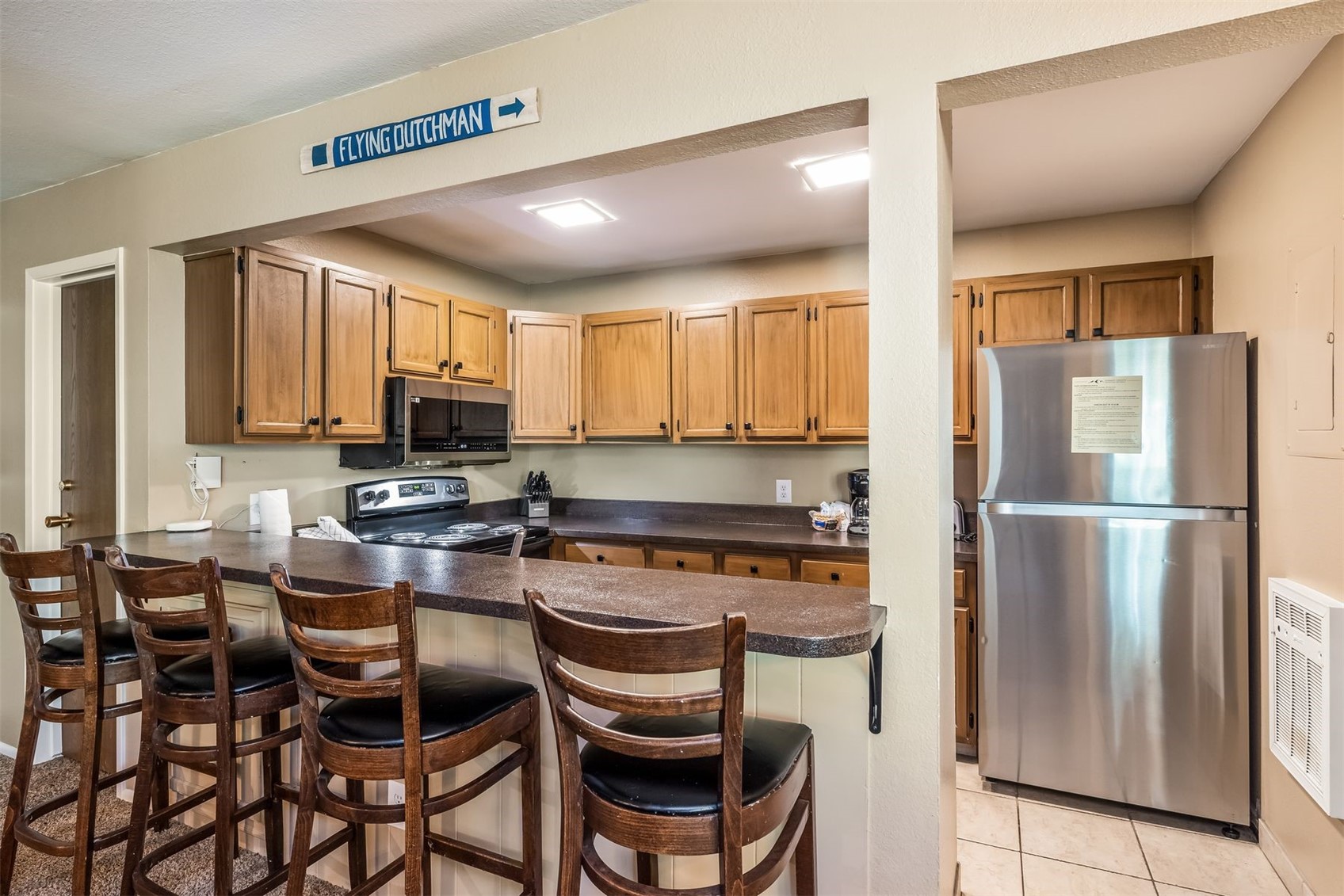 1977 Soda Ridge Road, Unit 1194 Keystone, CO 80435 - Photo 12 of 44 a kitchen with stainless steel appliances a refrigerator a stove a dining table and chairs