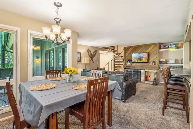 a view of a dining room with furniture wooden floor and chandelier