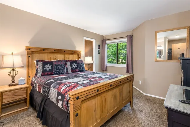 a bed sitting in a bedroom next to a window