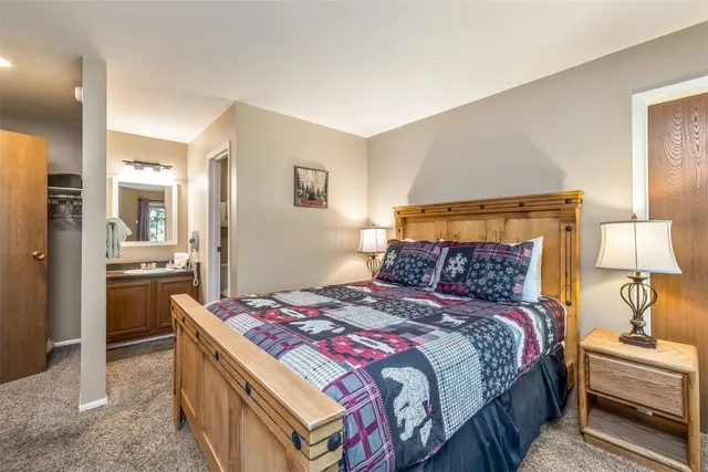 a bedroom with a bed and a lamp