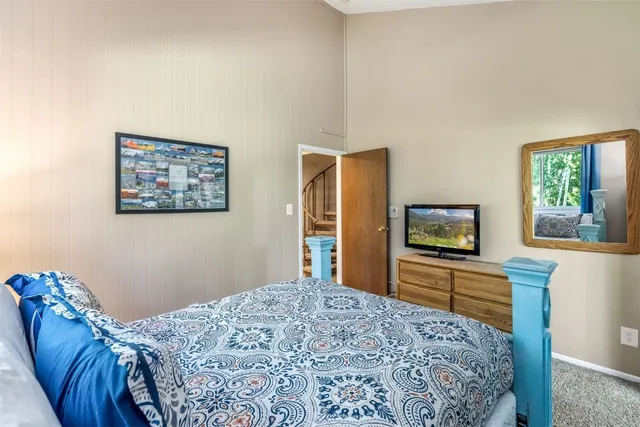 a bedroom with a bed and a flat screen tv