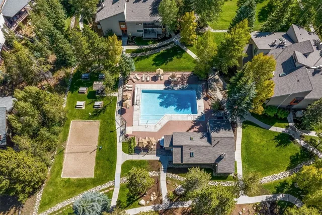 an aerial view of multiple houses with yard