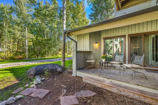 a view of a house with backyard porch and sitting area
