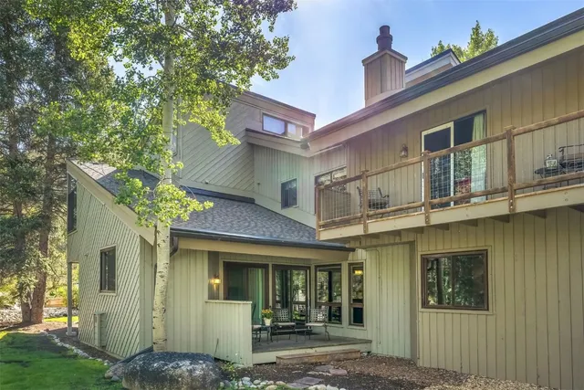 a front view of a house with a tree
