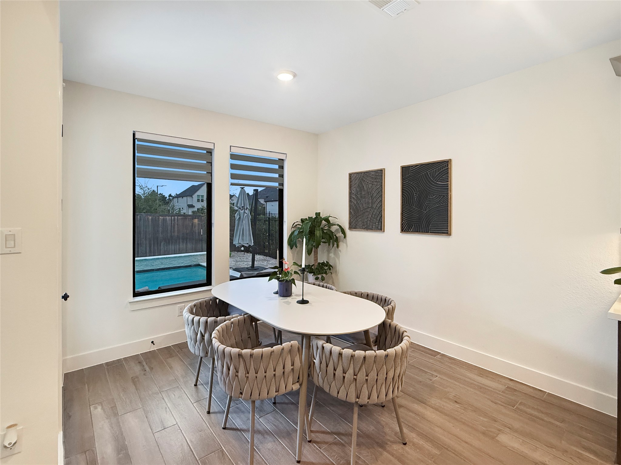 26918 Swanborough Road Spring, TX 77389 - Photo 18 of 50 Light-filled breakfast nook with soaring ceilings and expansive windows overlooking the beautiful backyard and pool, creating a warm and inviting space for dining.