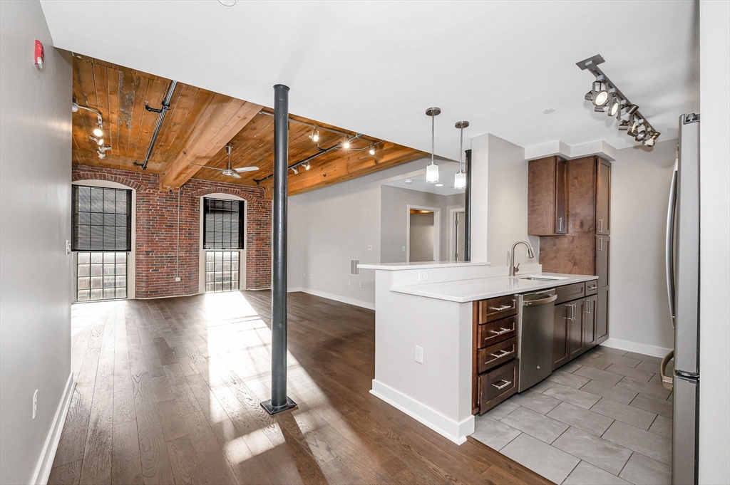 130 John Street, Unit 355 Lowell, MA 01852 - Photo 1 of 34 a view of a kitchen with a sink and a stove top oven