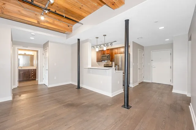 a view of a kitchen with a refrigerator and a sink