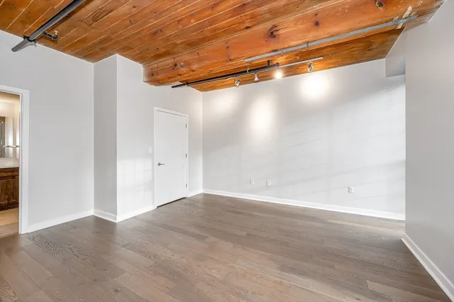 a view of a room with wooden floor