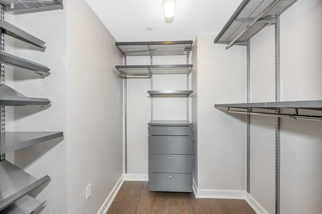 a view of walk in closet with empty racks