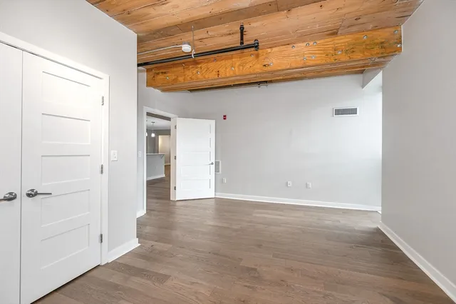 a view of a room with wooden floor
