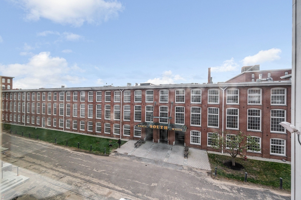 130 John Street, Unit 355 Lowell, MA 01852 - Photo 23 of 34 a view of a building with a garden