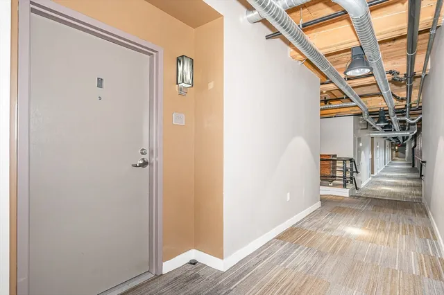 a view of hallway with wooden floor and stairs