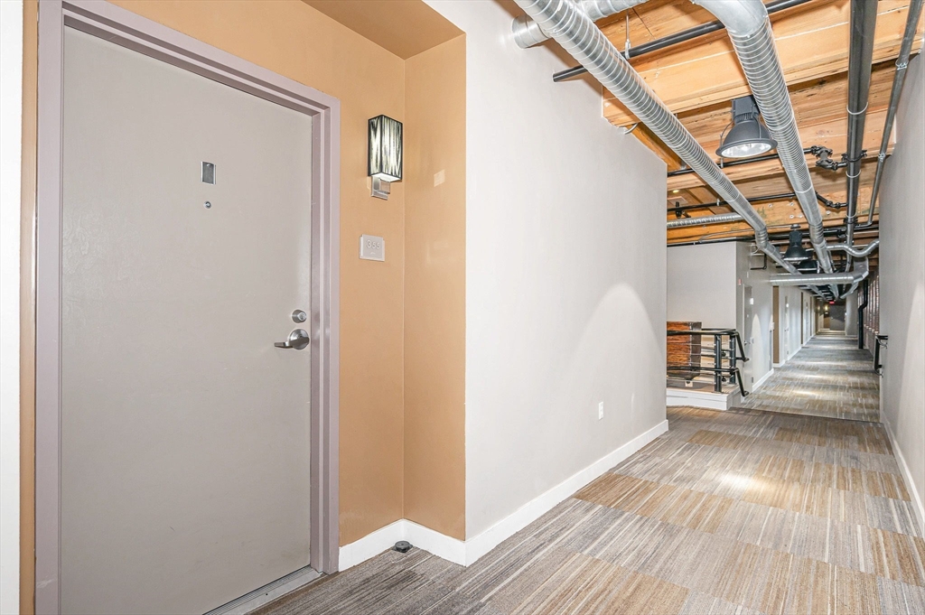 130 John Street, Unit 355 Lowell, MA 01852 - Photo 24 of 34 a view of hallway with wooden floor and stairs