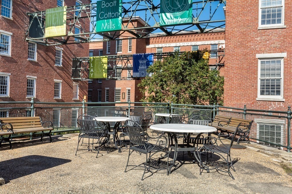130 John Street, Unit 355 Lowell, MA 01852 - Photo 30 of 34 a view of a patio with table and chairs and potted plants