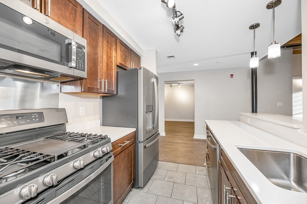 130 John Street, Unit 355 Lowell, MA 01852 - Photo 4 of 34 a kitchen with stainless steel appliances granite countertop a stove and a sink