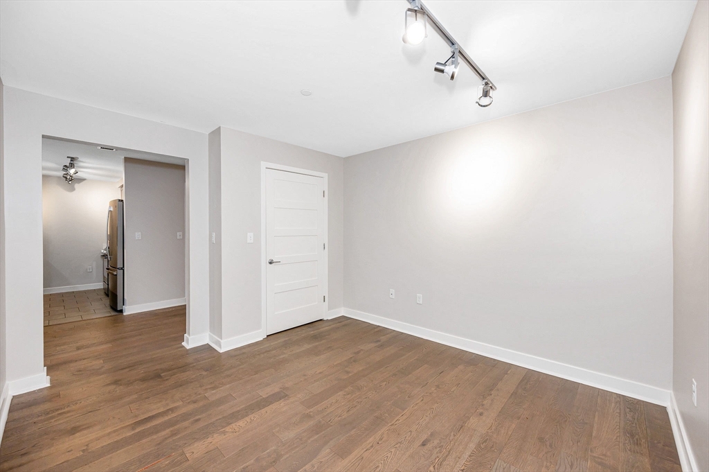 130 John Street, Unit 355 Lowell, MA 01852 - Photo 6 of 34 a view of an empty room with wooden floor