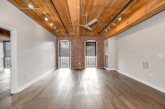a view of hallway with wooden floor