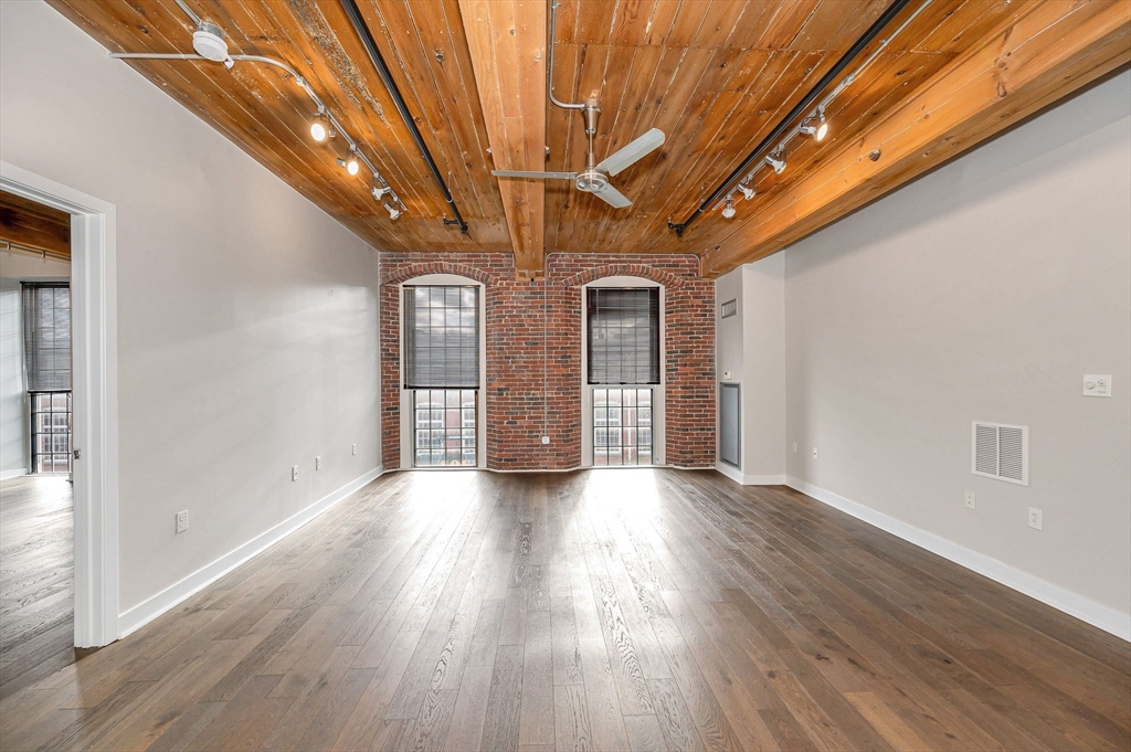 130 John Street, Unit 355 Lowell, MA 01852 - Photo 8 of 34 a view of hallway with wooden floor
