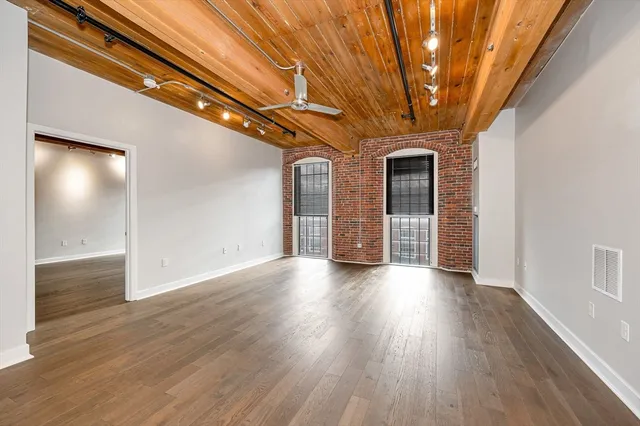a view of a livingroom with wooden floor and staircase